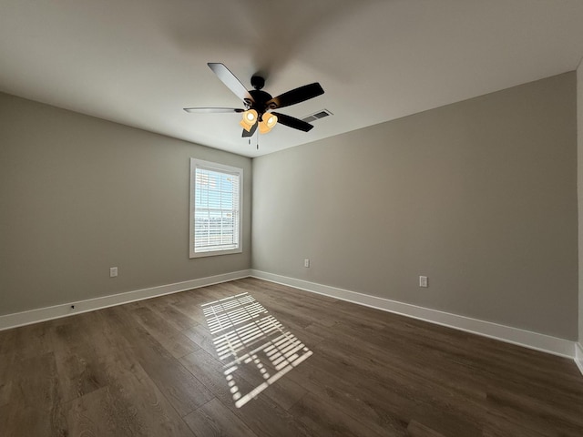 empty room with dark wood-type flooring and ceiling fan