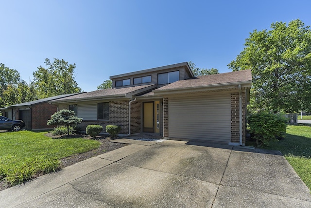 view of front of home featuring a garage and a front lawn