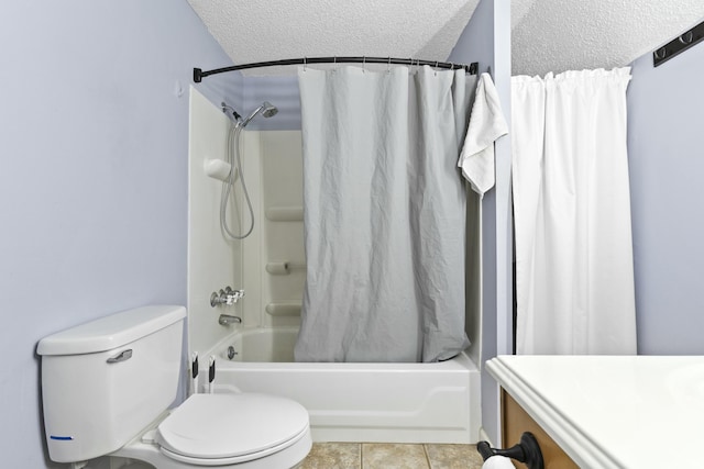 full bathroom featuring tile patterned floors, toilet, a textured ceiling, vanity, and shower / bath combo with shower curtain