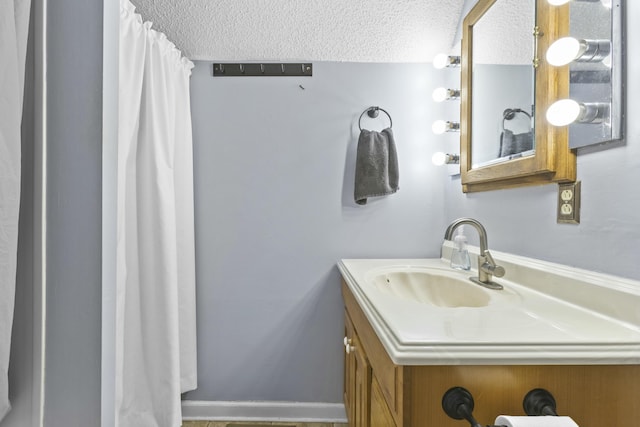 bathroom featuring vanity and a textured ceiling