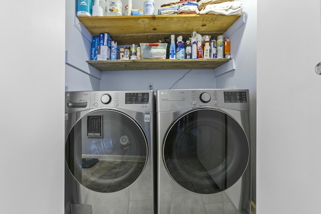 clothes washing area with washing machine and clothes dryer