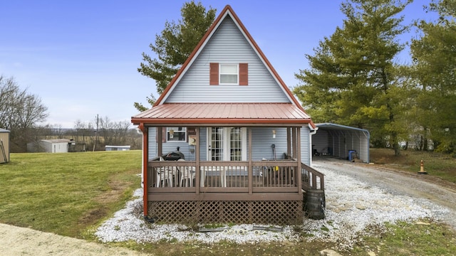 rear view of property featuring a carport and a yard