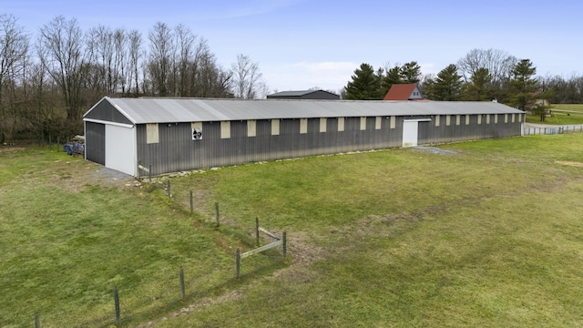 exterior space featuring an outdoor structure and a lawn