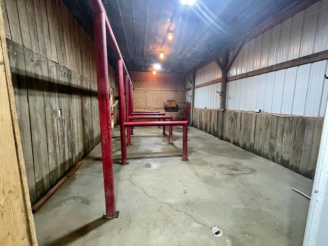 basement featuring wooden walls