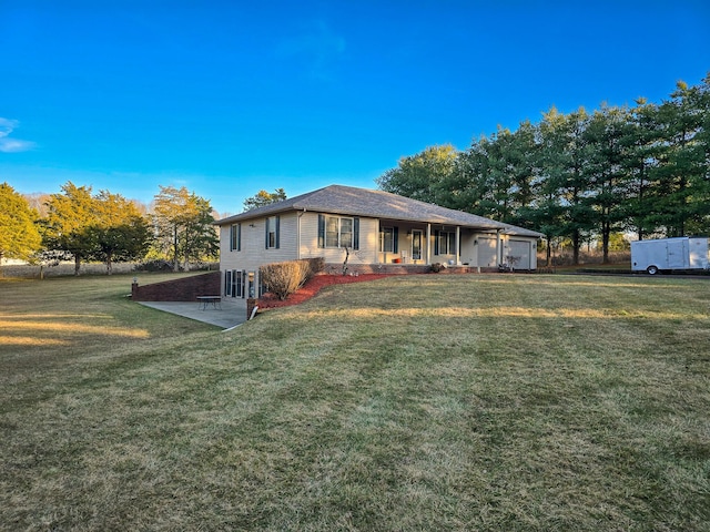 rear view of house featuring a porch, a patio, and a yard