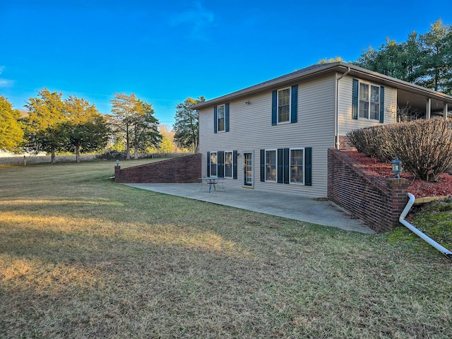 rear view of property featuring a patio area and a lawn