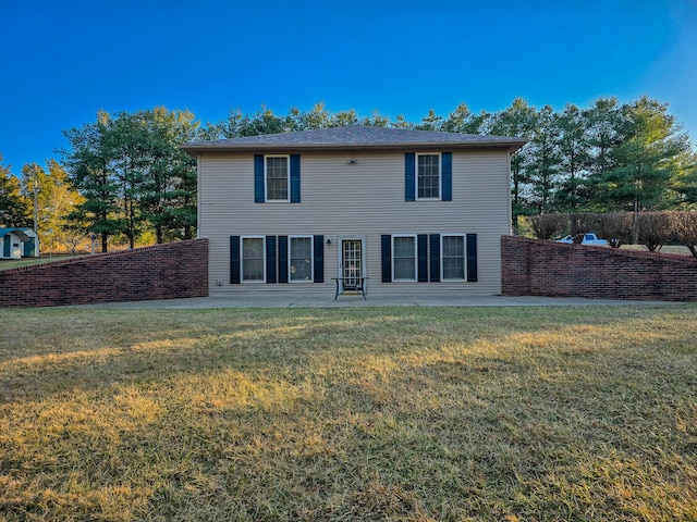 view of front facade with a front lawn and a patio area