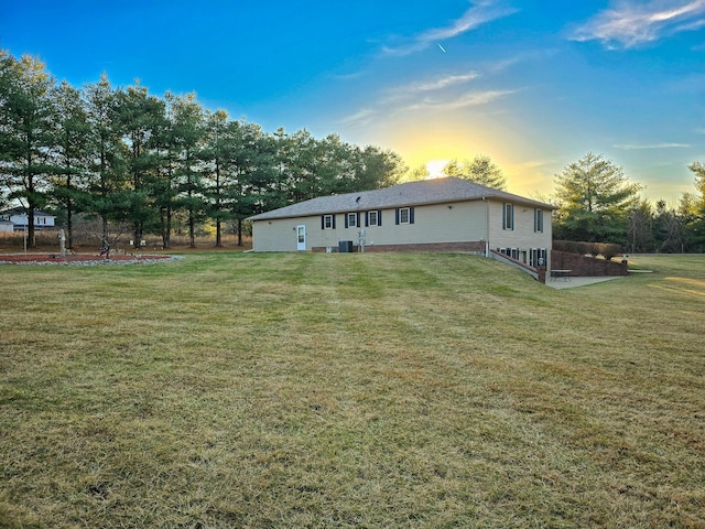 back house at dusk with a yard