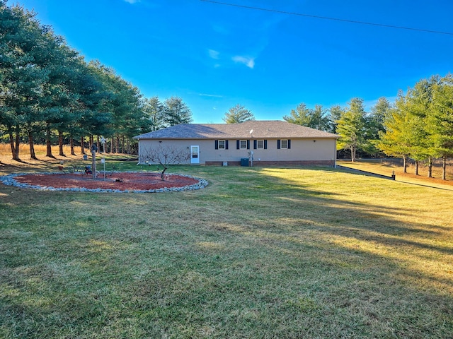 rear view of property with a yard