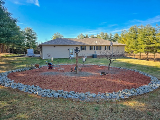 exterior space featuring central AC, a yard, and an outdoor fire pit