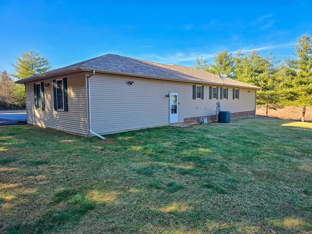 back of property with cooling unit and a yard