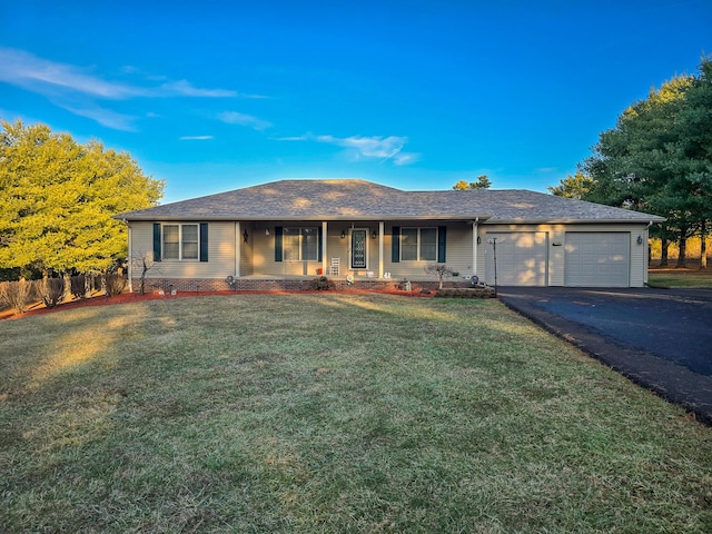 ranch-style home with a garage, a front lawn, and covered porch