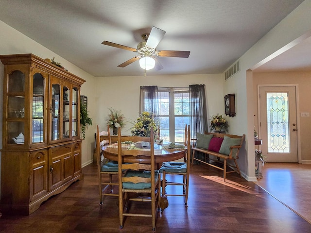 dining area with ceiling fan and dark hardwood / wood-style flooring