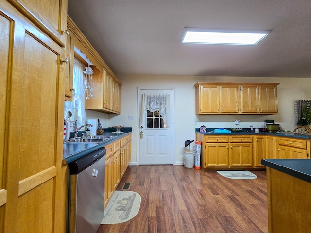 kitchen with dark hardwood / wood-style flooring, sink, and dishwasher