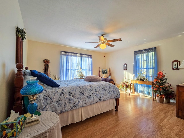 bedroom with wood-type flooring and ceiling fan