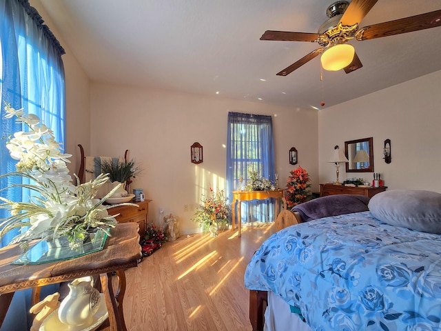 bedroom with ceiling fan and hardwood / wood-style floors