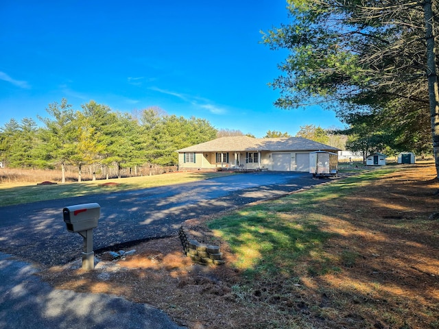 view of front of property featuring a garage and a front lawn