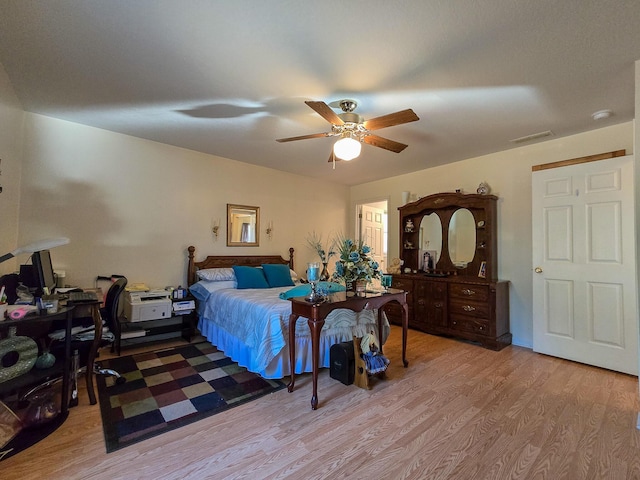 bedroom with light hardwood / wood-style flooring and ceiling fan