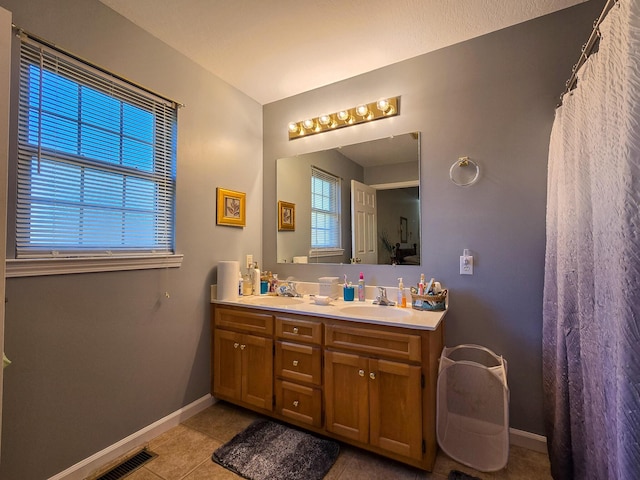 bathroom with vanity and tile patterned flooring