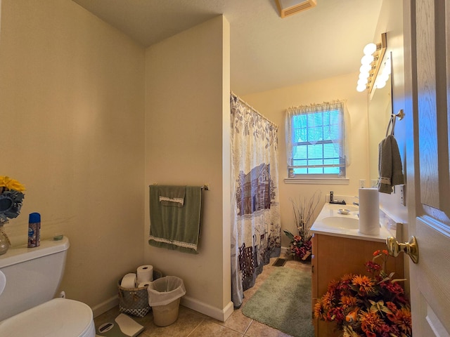 bathroom featuring vanity, curtained shower, tile patterned floors, and toilet