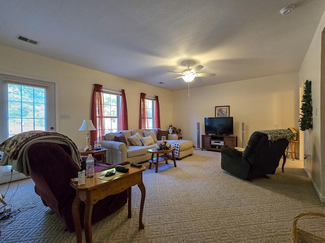 living room featuring carpet flooring and ceiling fan