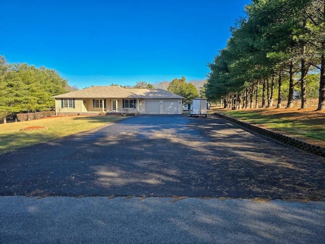 view of front of house featuring a garage and a front lawn