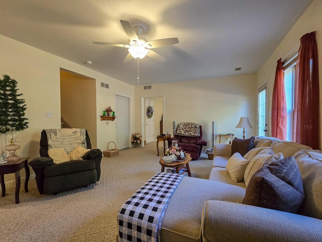 carpeted living room featuring ceiling fan