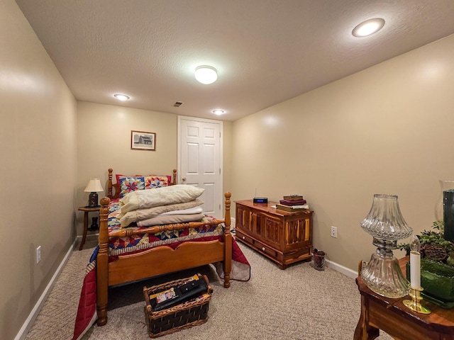 carpeted bedroom with a textured ceiling