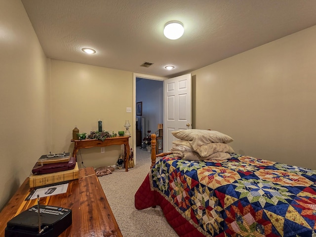 carpeted bedroom featuring a textured ceiling