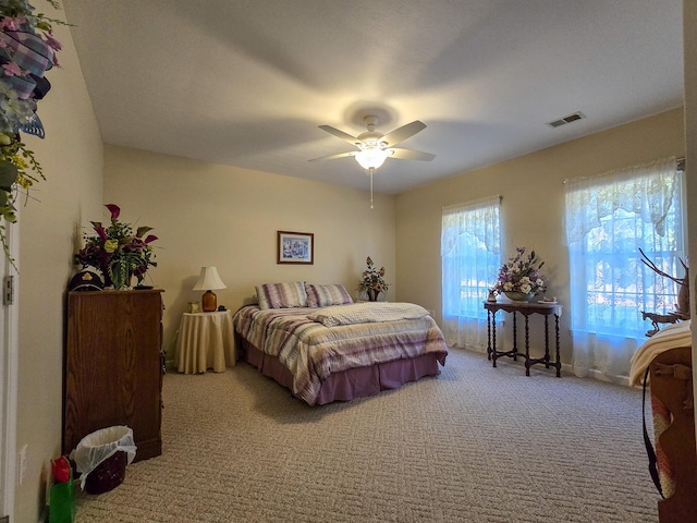 carpeted bedroom with ceiling fan