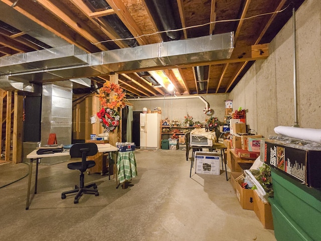 basement with white fridge with ice dispenser