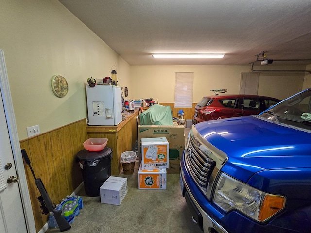 garage with a garage door opener and wooden walls