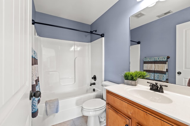 full bathroom featuring tile patterned floors, bathing tub / shower combination, vanity, and toilet