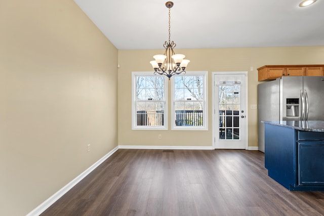 unfurnished dining area with dark hardwood / wood-style floors and a notable chandelier