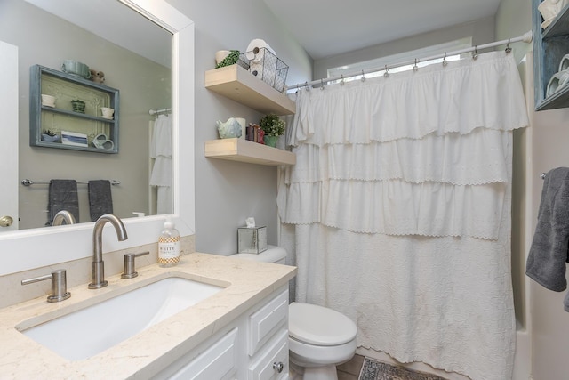 bathroom featuring vanity, a shower with shower curtain, and toilet