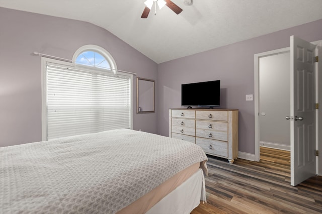 bedroom with dark wood-type flooring, ceiling fan, and lofted ceiling