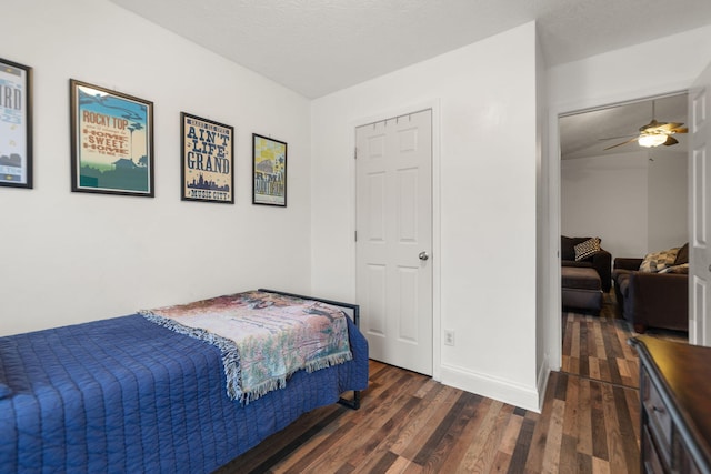 bedroom with dark hardwood / wood-style flooring