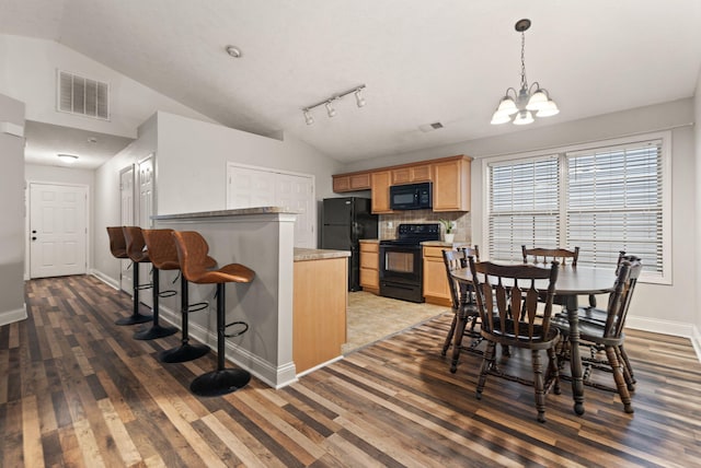 dining room with lofted ceiling, dark hardwood / wood-style floors, and a notable chandelier