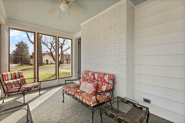 sunroom featuring a ceiling fan and visible vents