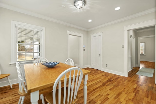 dining room featuring baseboards, ornamental molding, recessed lighting, and light wood-style floors