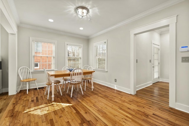 dining area with hardwood / wood-style flooring, baseboards, ornamental molding, and recessed lighting