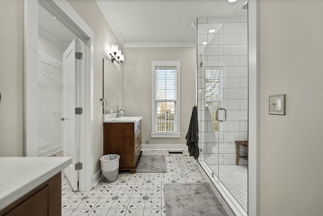 full bathroom featuring vanity, baseboards, a spacious closet, ornamental molding, and a stall shower