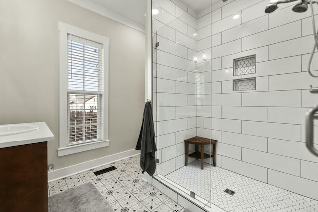 bathroom featuring baseboards, visible vents, tile patterned flooring, a tile shower, and vanity