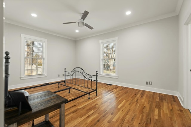 bedroom featuring multiple windows, baseboards, and crown molding