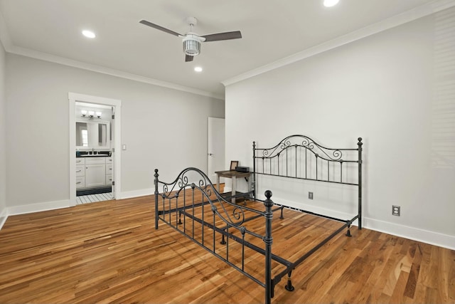 bedroom with ornamental molding, recessed lighting, wood finished floors, and baseboards