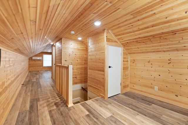 bonus room with lofted ceiling, wood ceiling, wooden walls, and wood finished floors