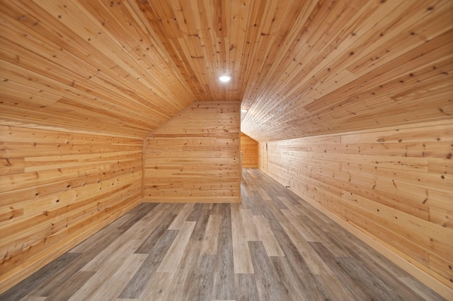 bonus room with vaulted ceiling, a sauna, wooden walls, wood finished floors, and wooden ceiling