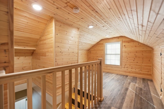 additional living space featuring lofted ceiling, wood ceiling, wood walls, and wood finished floors