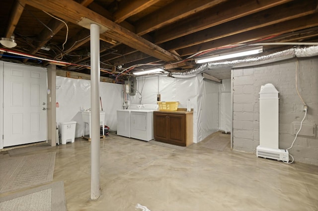 unfinished basement featuring a sink and washer and dryer