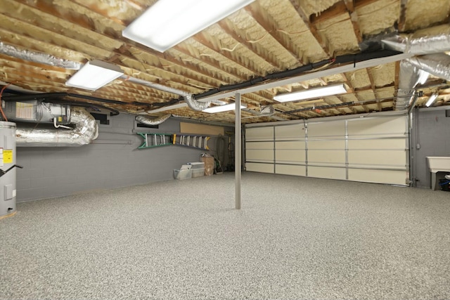 garage with concrete block wall and water heater